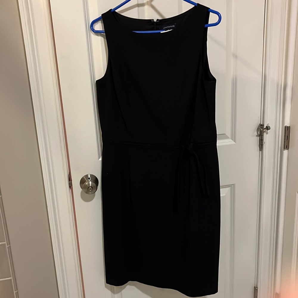 Ann Taylor black dress with decorative tie in front. Size 12. Zips up back.